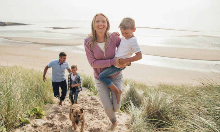 Family Walking Up a Sand Dune