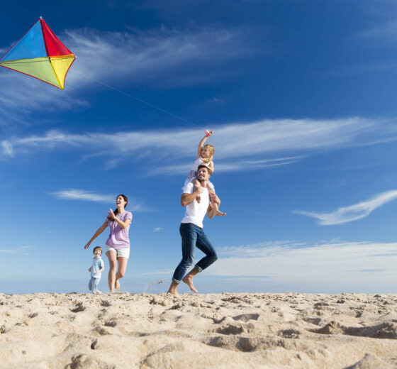 Family on the Beach Flting a Kite