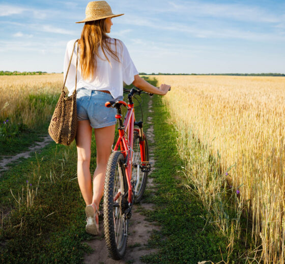 Beautiful summer landscape with woman and bike